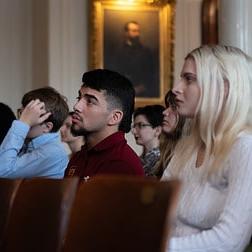 Students seated in Old Main during ceremony